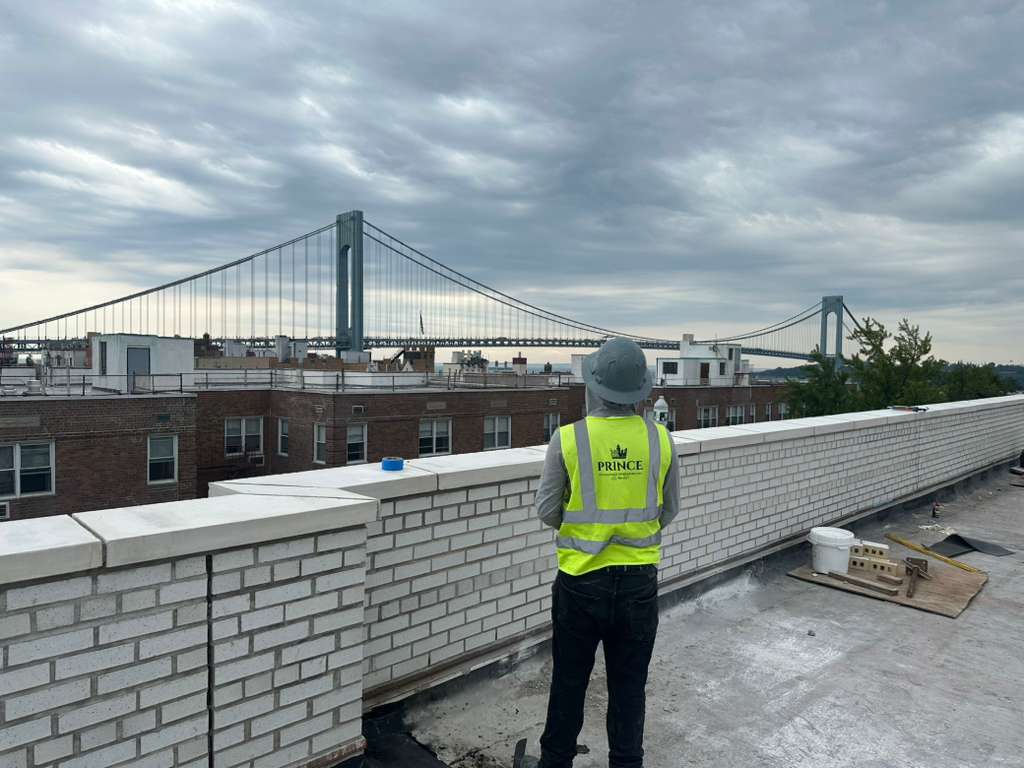 Prince crew member on a New York rooftop with the Verrazzano-Narrows Bridge in the background